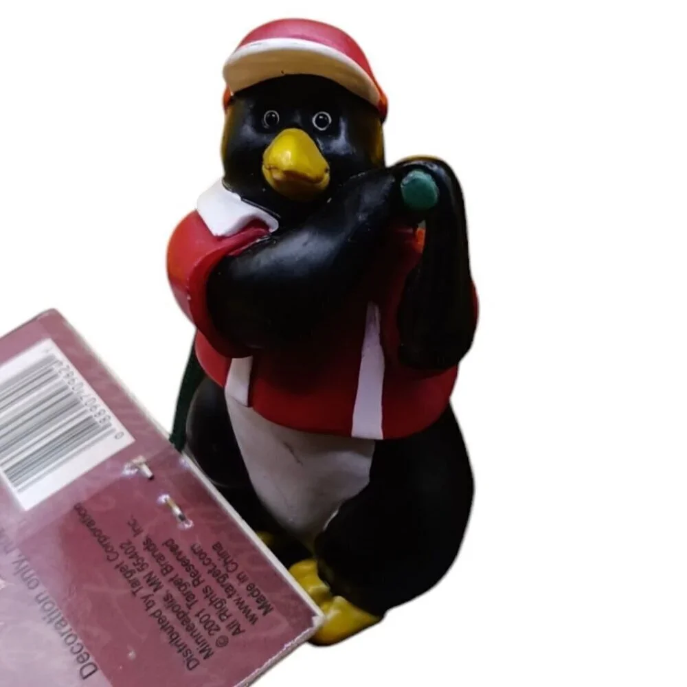 Trim a traditional golfing penguin christmas ornament